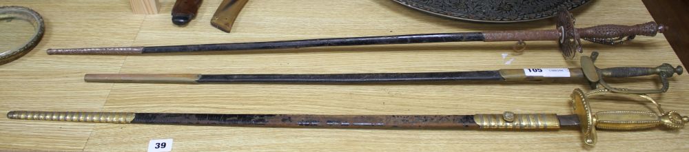 A cut steel dress sword by Ede & Ravenscroft of London and two brass hilted dress swords